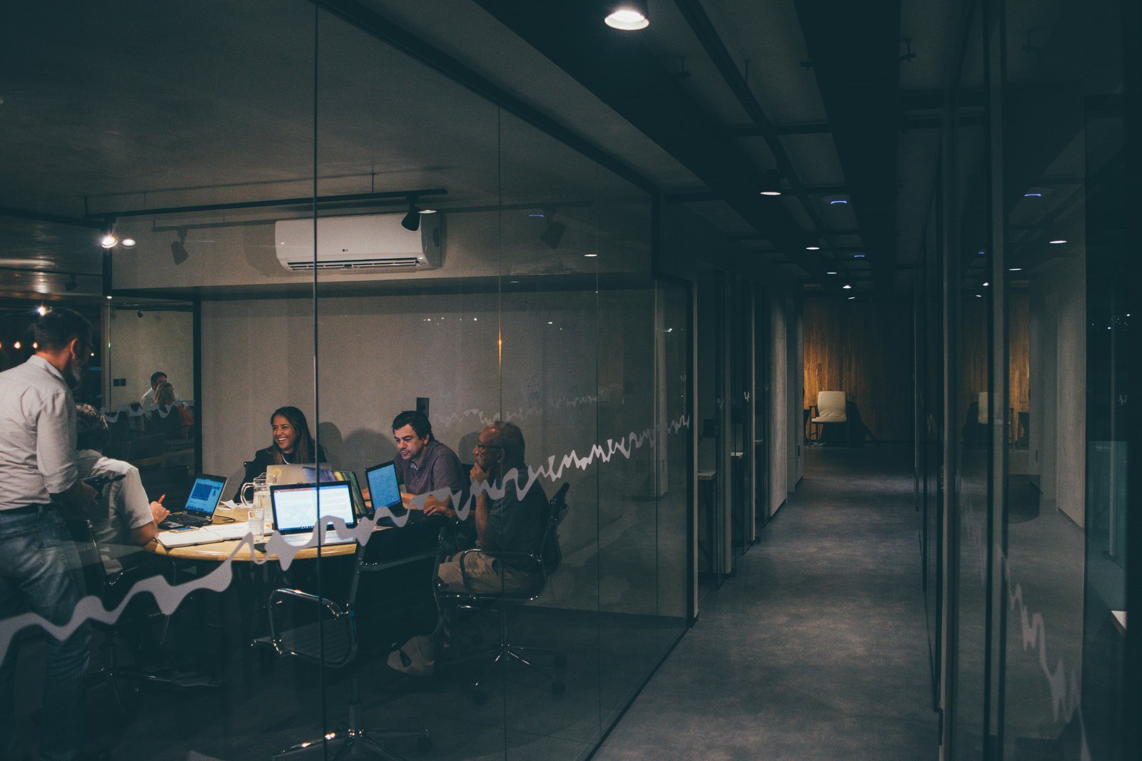 A team collaborating in a glass-walled office